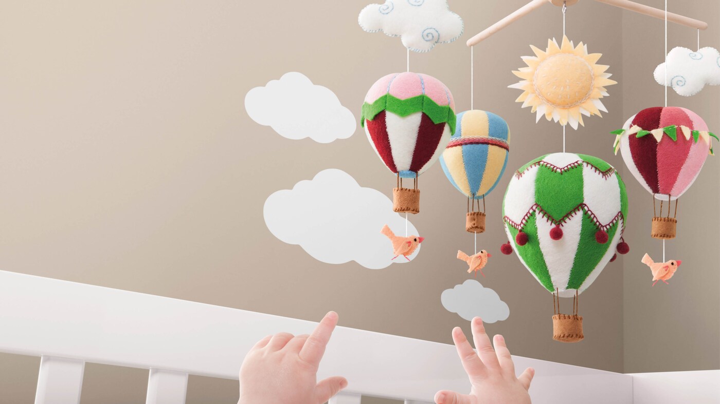 Babies become more and more fascinated by movement as they develop, so hanging a mobile from the ceiling above their crib is a quick and easy way to grab their attention.