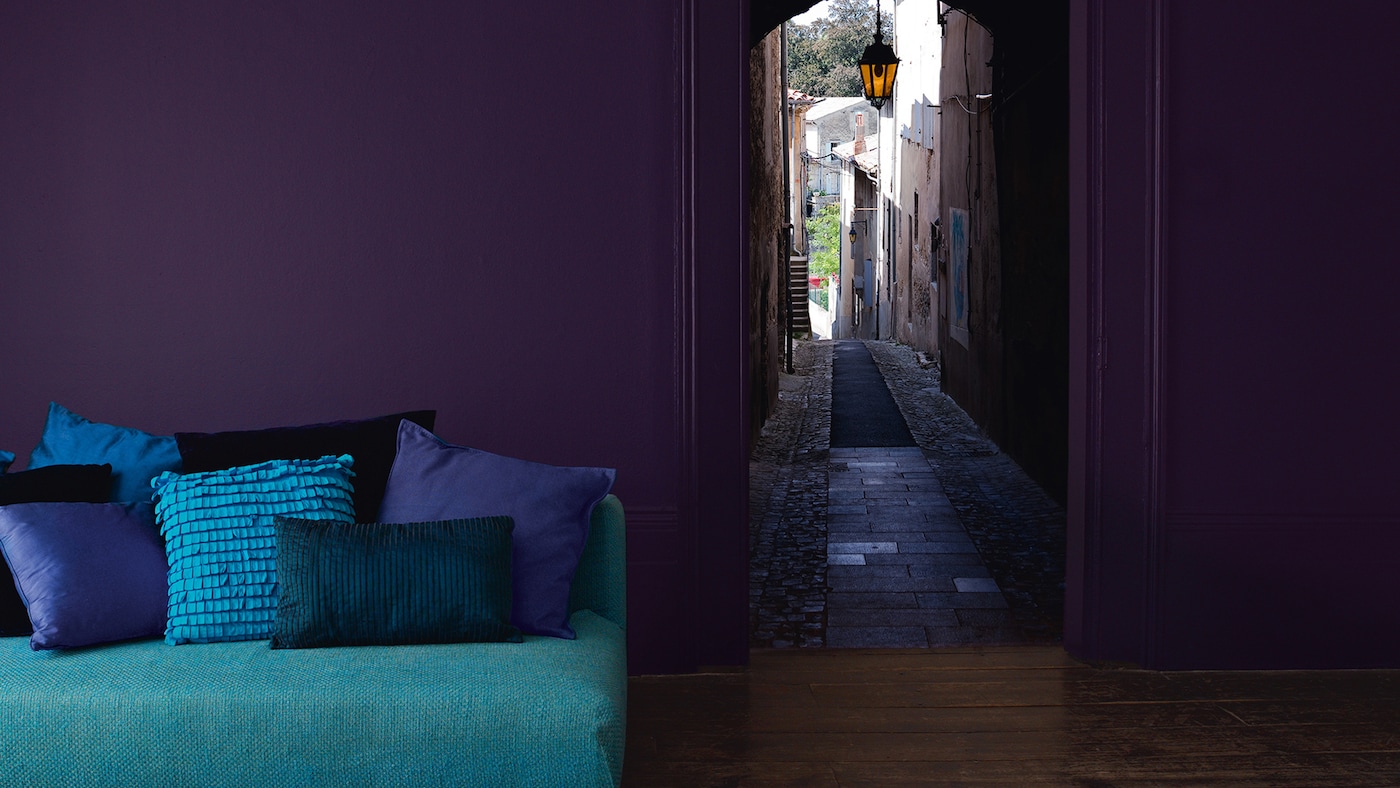 Living room decorated in striking shades of purple, teal and turquoise. 