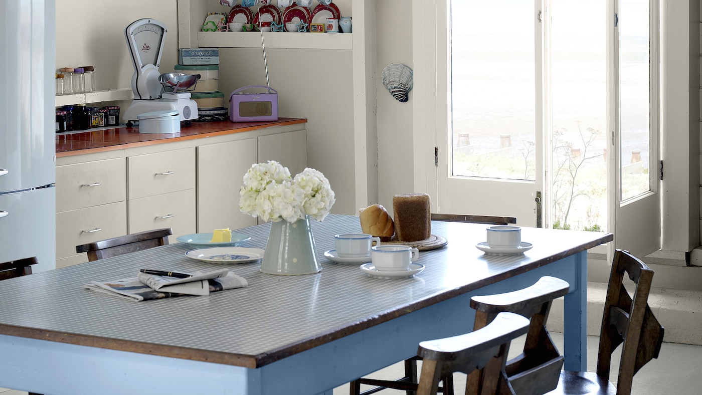 Blend warm blues and cool neutrals to create a stylish English country kitchen