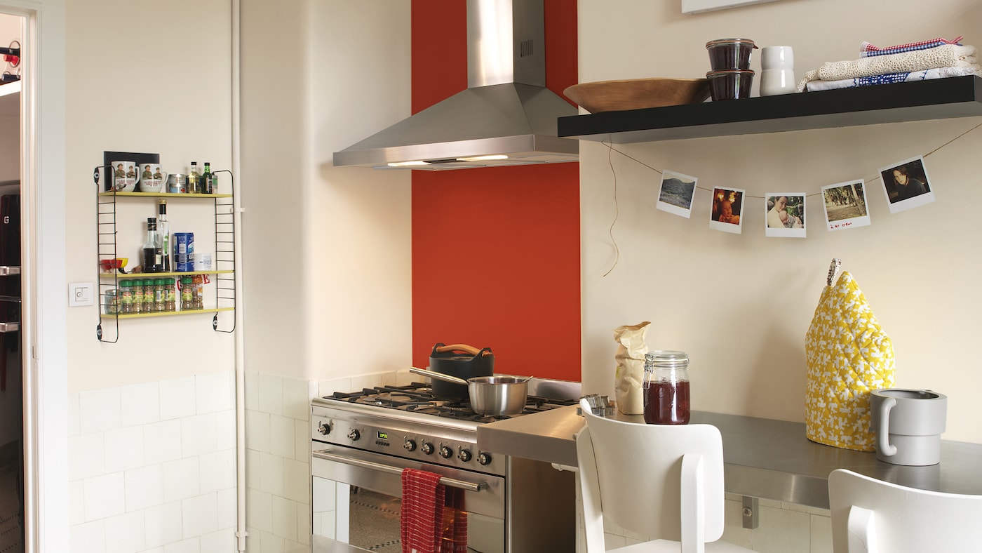 Neutral kitchen with one bright red wall