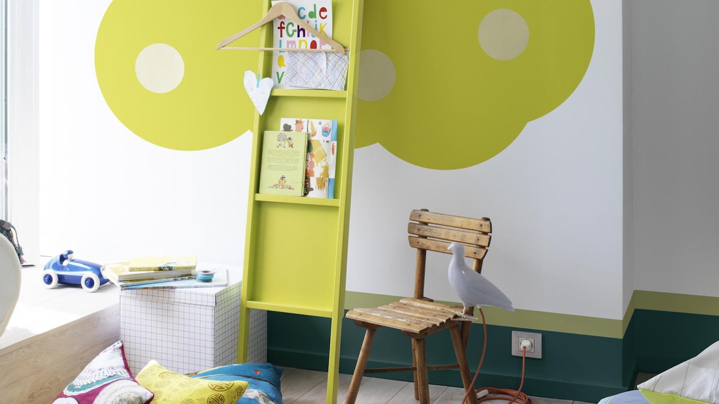 Bright green tree painted in children’s room