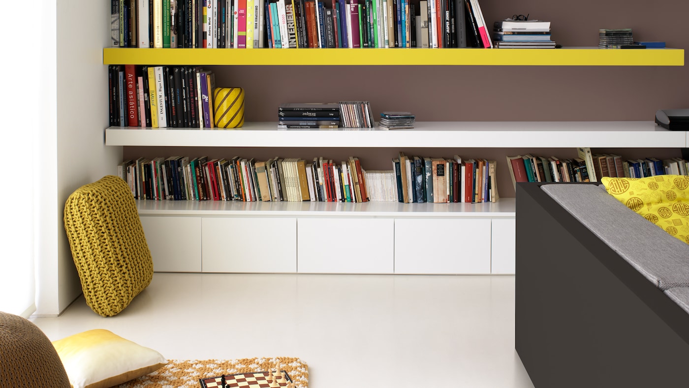 Pops of mustard yellow animate this white living space.
