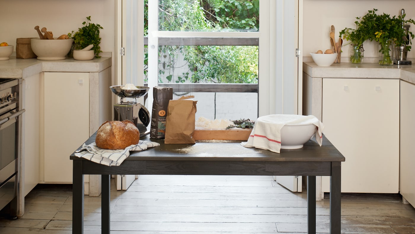Green shelves on a cream background add impact in this kitchen.
