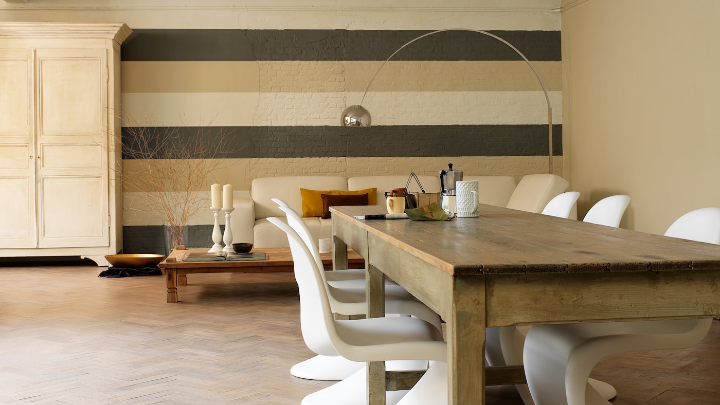 A wall of wide stripes in warm, neutral shades draws the eye.