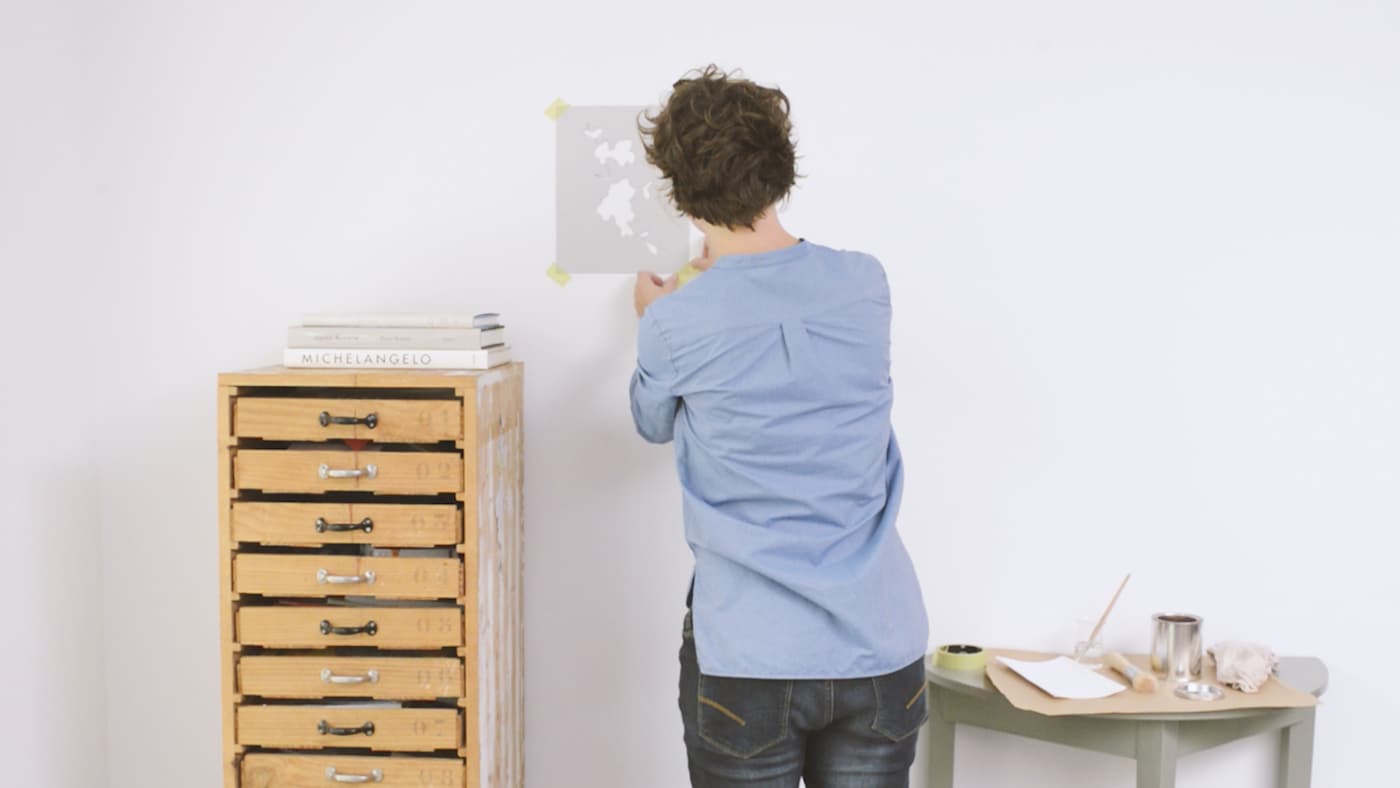 Securing a stencil to the wall