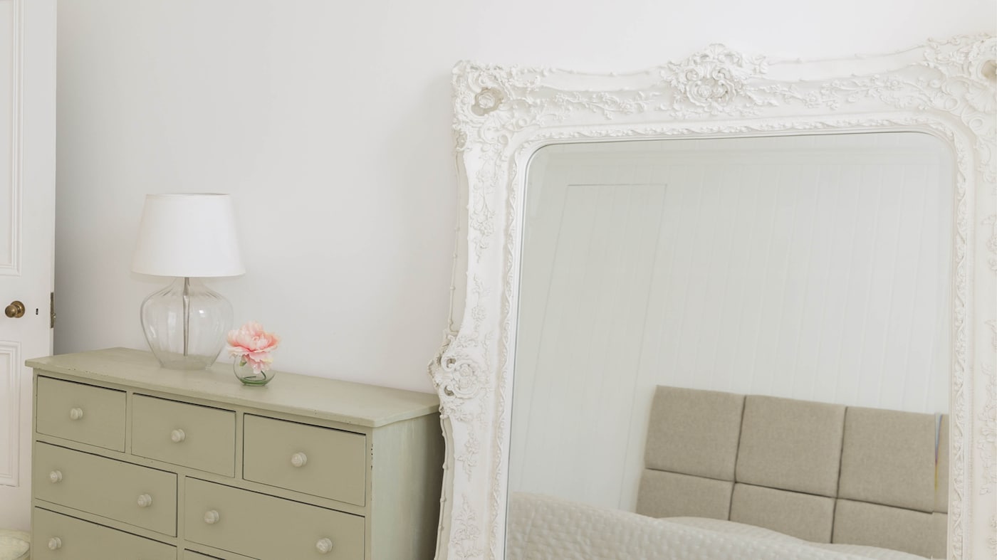 By leaning a large mirror against a wall you’ll give the impression that the room is expanding and opening up at head height.