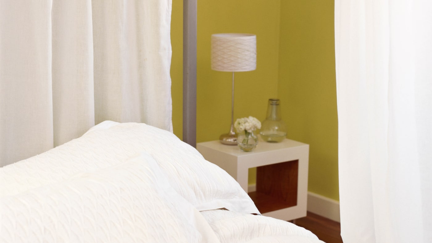 A curtain suspended from the ceiling that draws around the crib is an easy way to create a makeshift “room” and give both baby and your guest a little privacy.