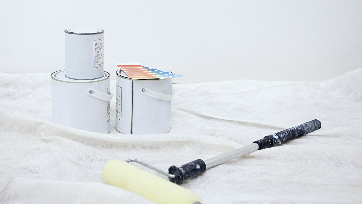 Professional painting equipment on dustsheet.