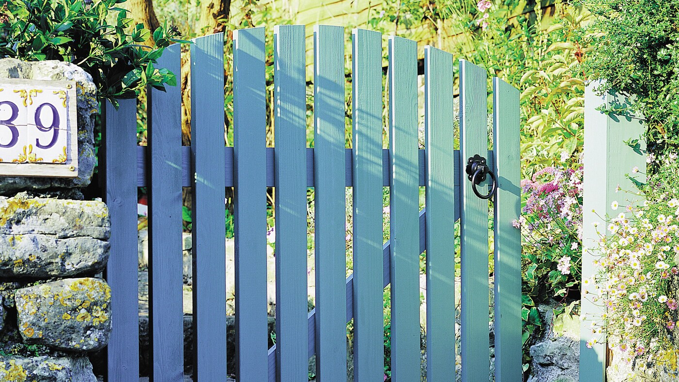 Painted wooden gate brightens the entrance to your home