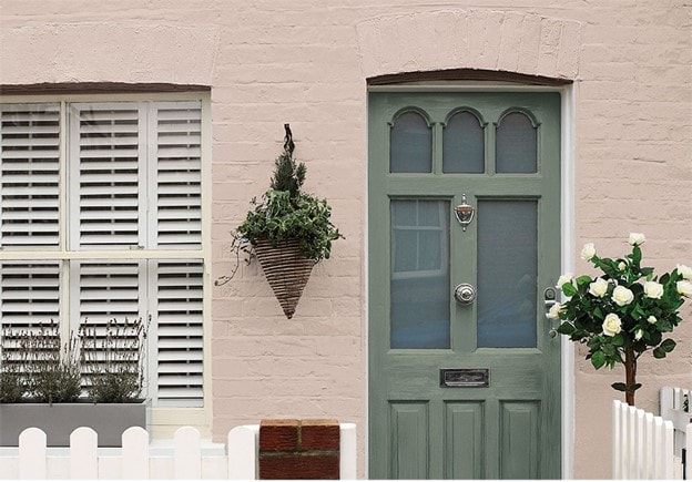 Sandstone walls and green glade front door