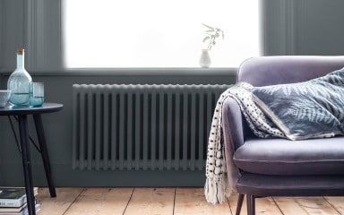 Dark Grey Living Room Wall With A White Fireplace And Metallic Décor