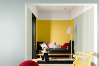 Living Room Decorated With Dulux Bright Yellow Paint And Black Décor Accents