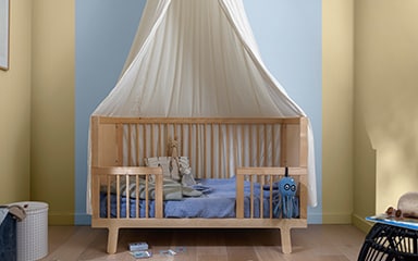 Child’s room with cot and striped wall