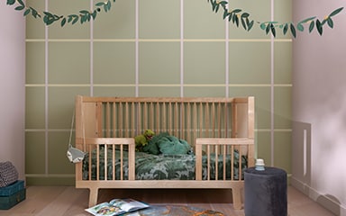 Kid’s bedroom with a green checkerboard feature wall and light purple opposing walls