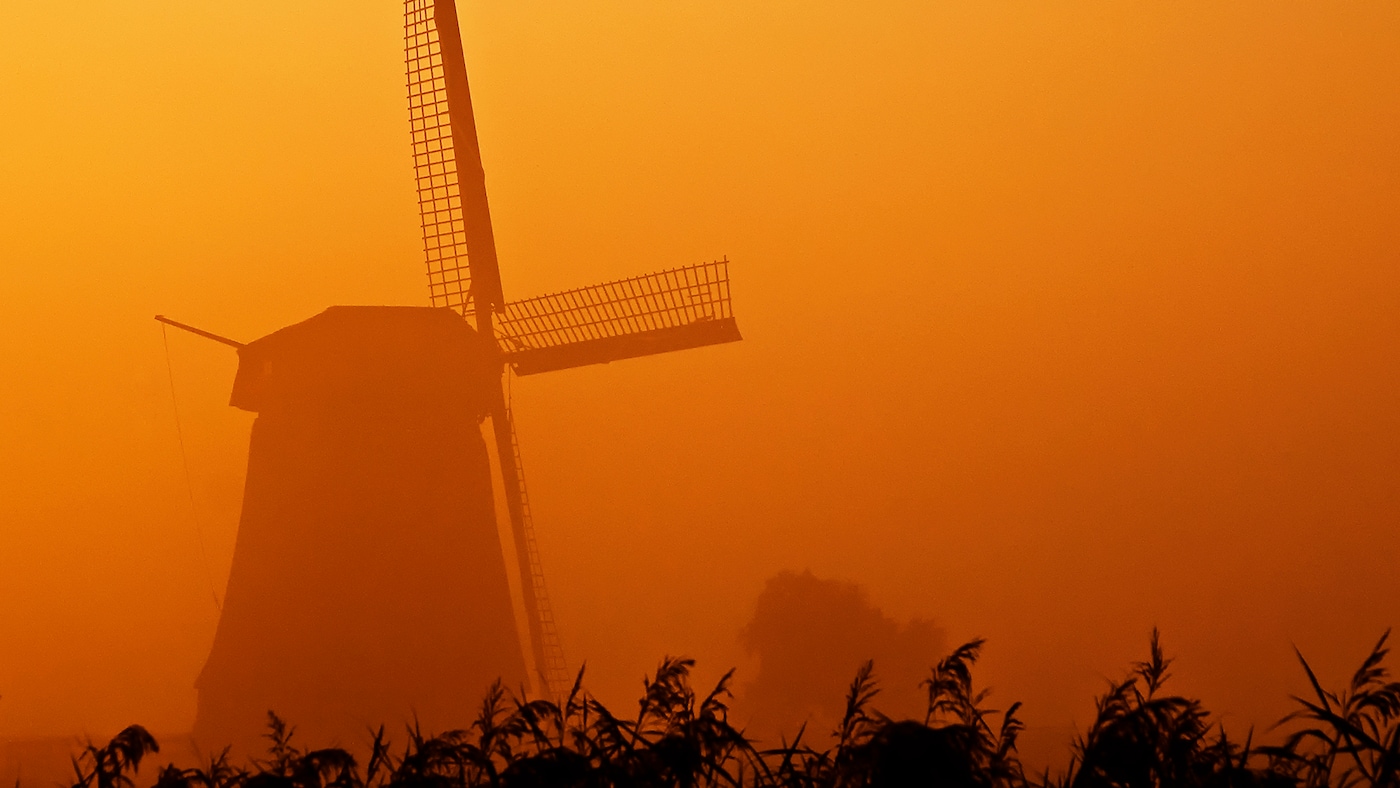 Dutch windmill in orange sunset