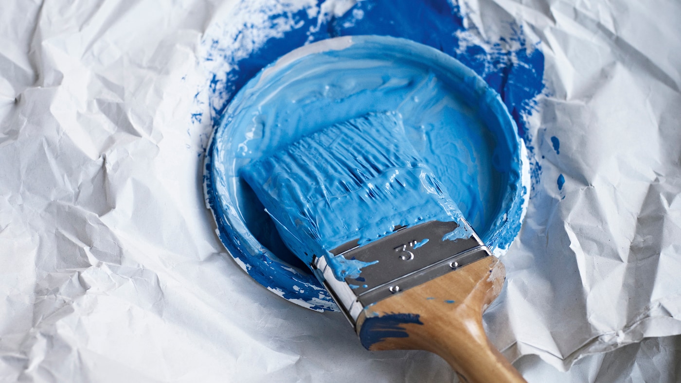 Paint brush covered in blue paint 