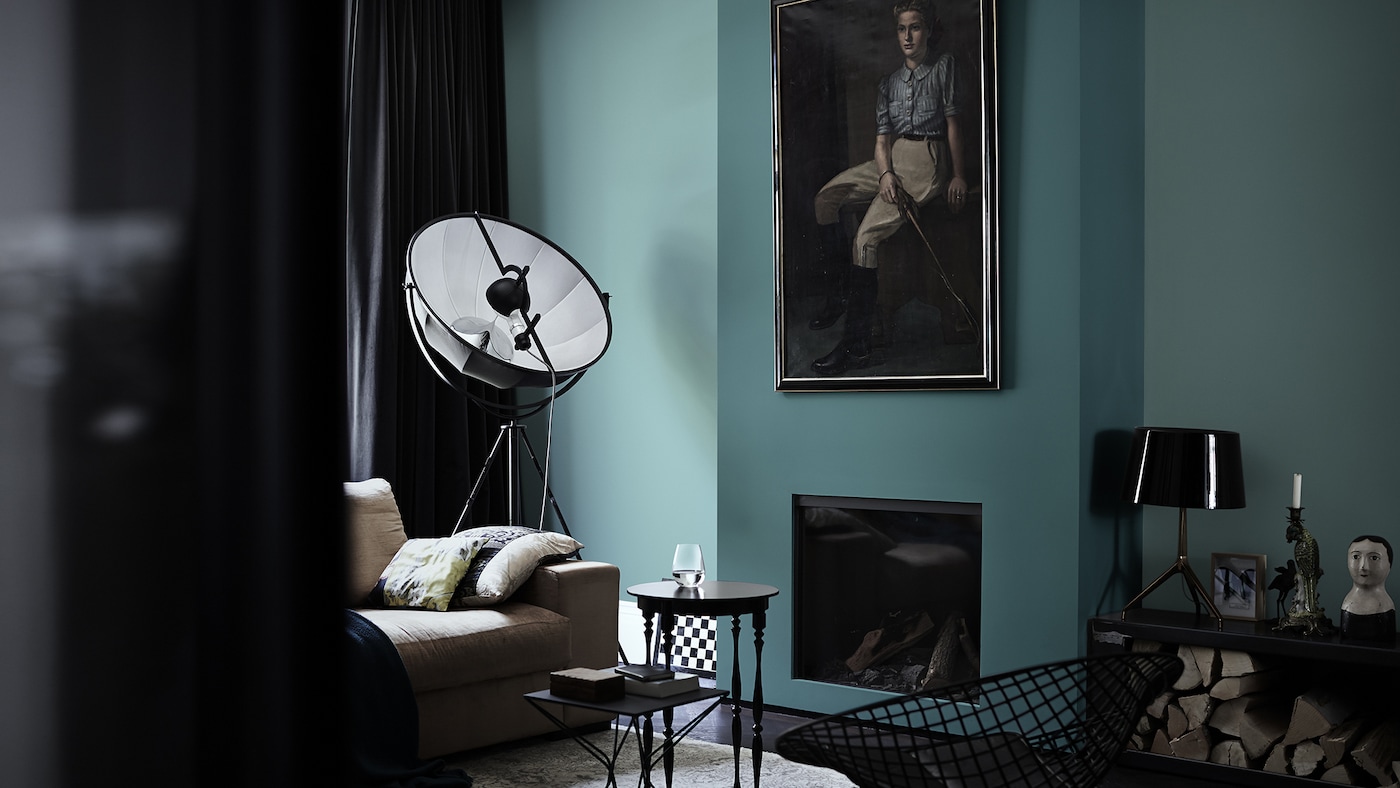 For bold living room decor ideas, contrast beautiful lagoon blue walls with furniture in black and charcoal shades.
