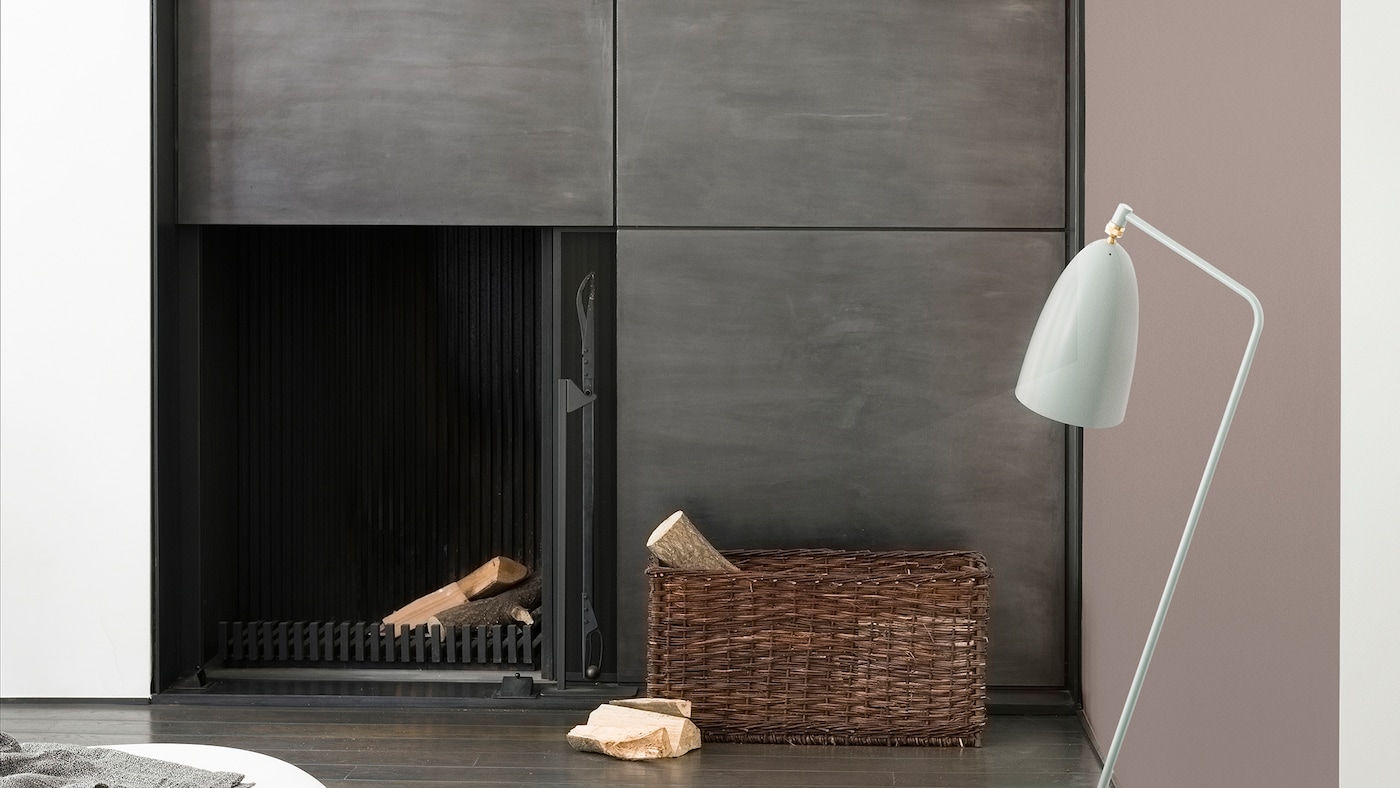 Enhance a minimalist metal fireplace with warm, rich neutrals like dove grey and charcoal.

