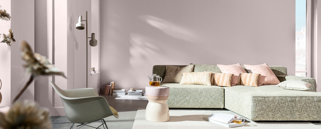 Living room with straw-colored walls and white sofa on the left