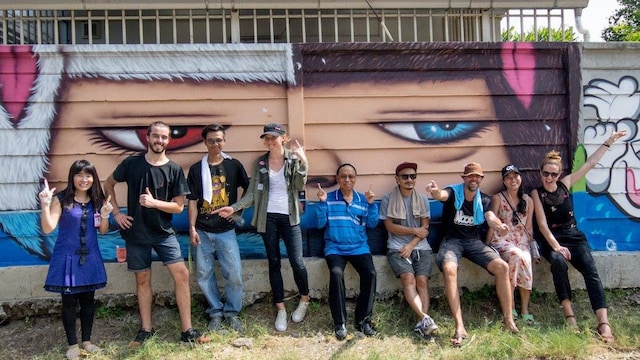 people in front of the painted wall