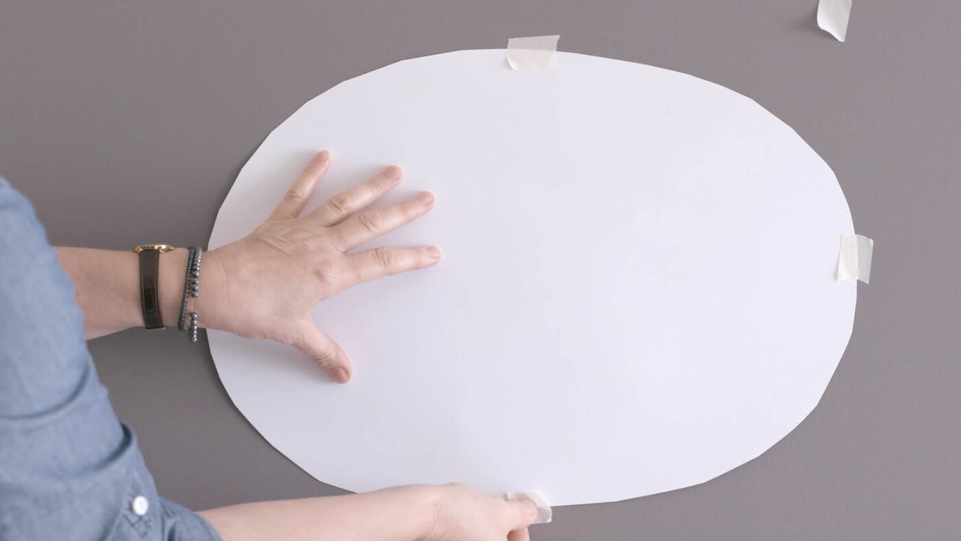 Tape your oval to the area you’d like to paint