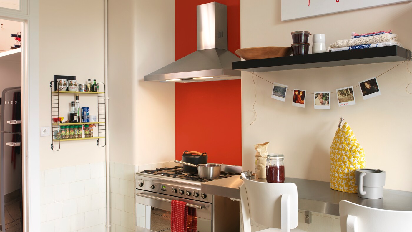 Use a bright standpoint colour to add energy to a plain kitchen.
