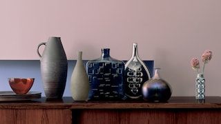 Contrast dusky pink with warm wood tones