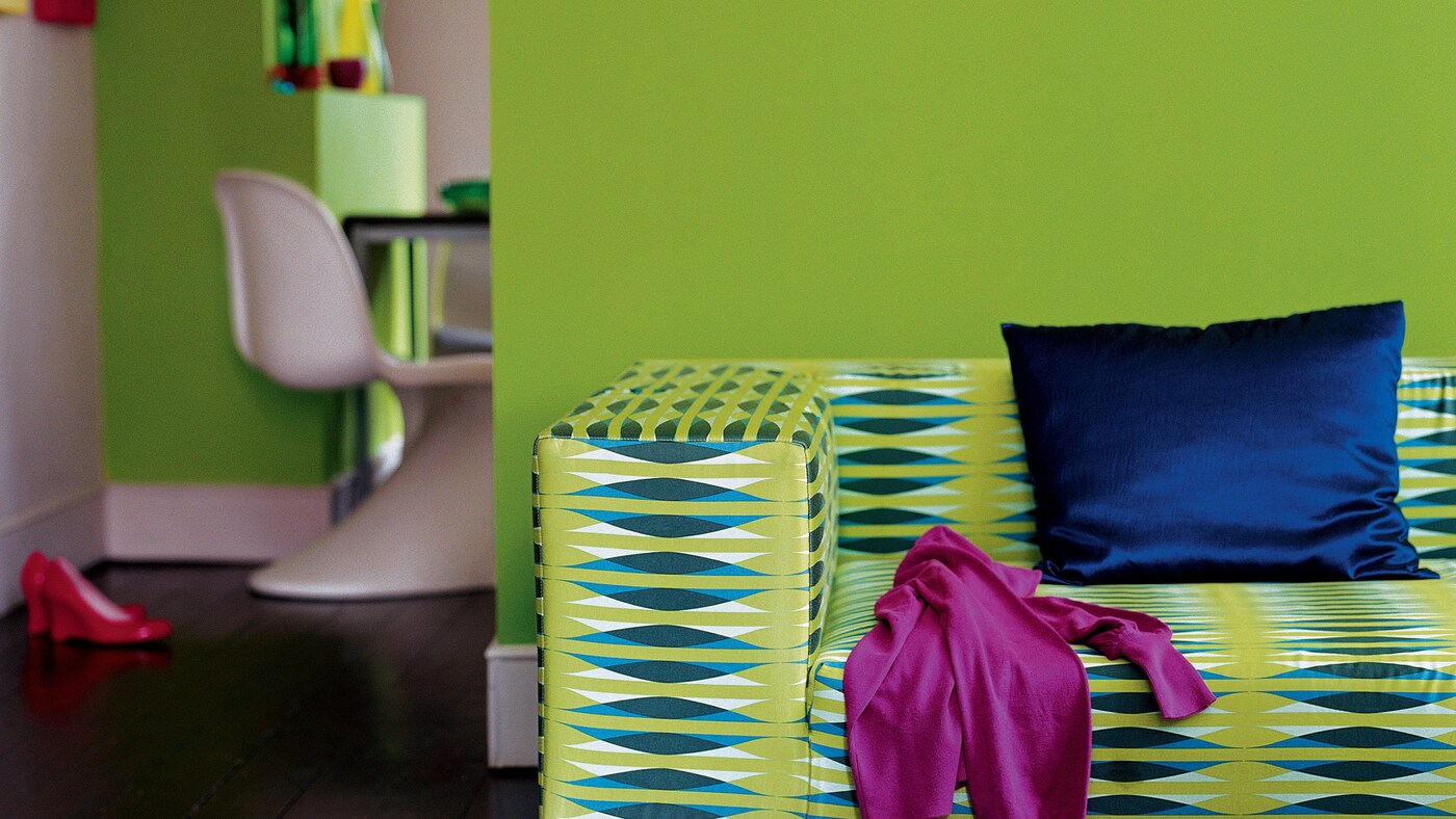 Match a striking lime green wall with dramatic dark wood floors.
