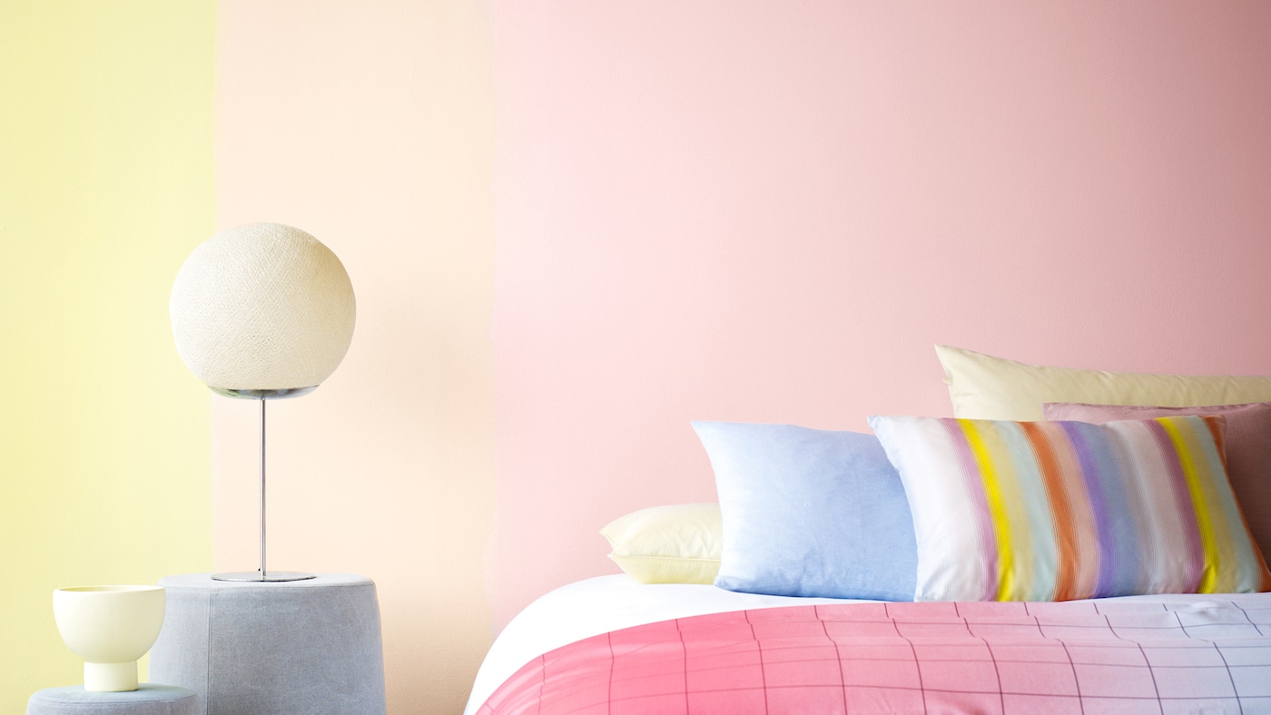 Pale pink and yellow shades create a harmonious colour scheme in a bedroom