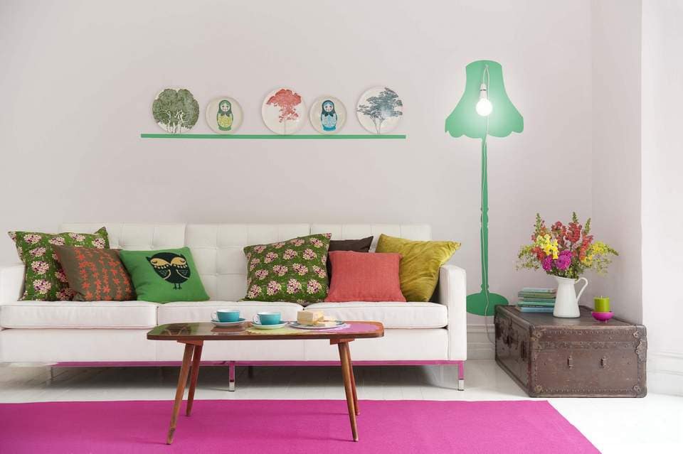 White living room with pink and green details