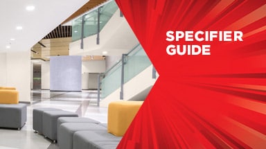 Modern commercial interior with glass railings, contemporary seating, and geometric architecture featuring "Specifier Guide" text on a red overlay design.