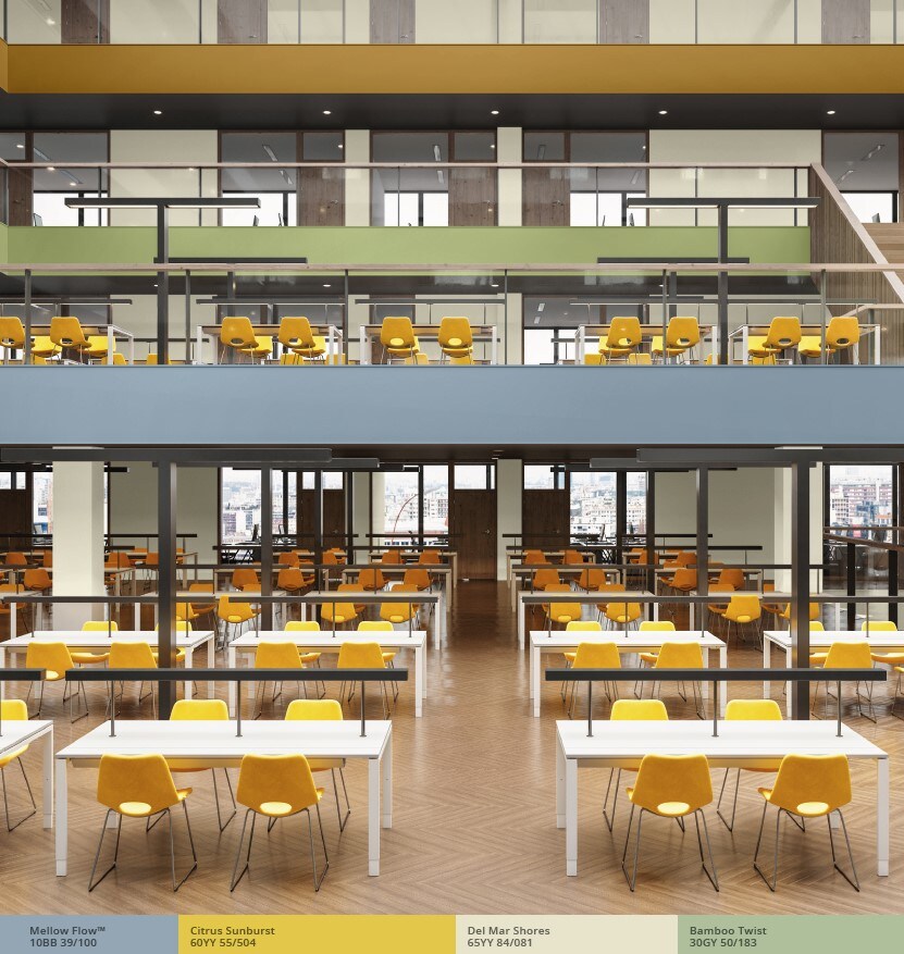 Open-plan classroom with upper floor balconies painted in blue, green and yellow