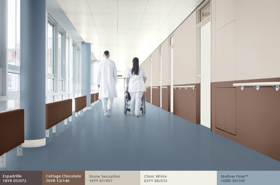 Hospital corridor with blue floor and pillars