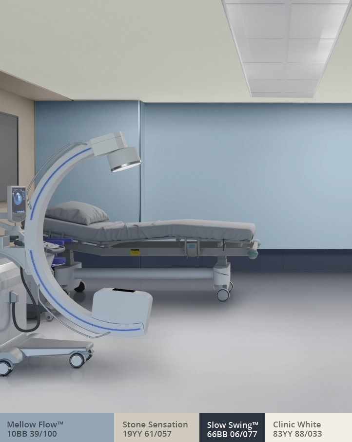 Treatment room with blue back wall and hospital bed 