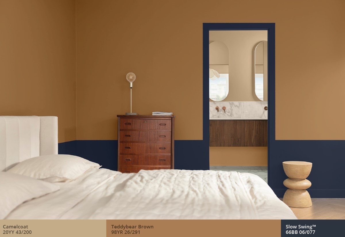 Hotel bedroom with a split wall featuring blue and brown