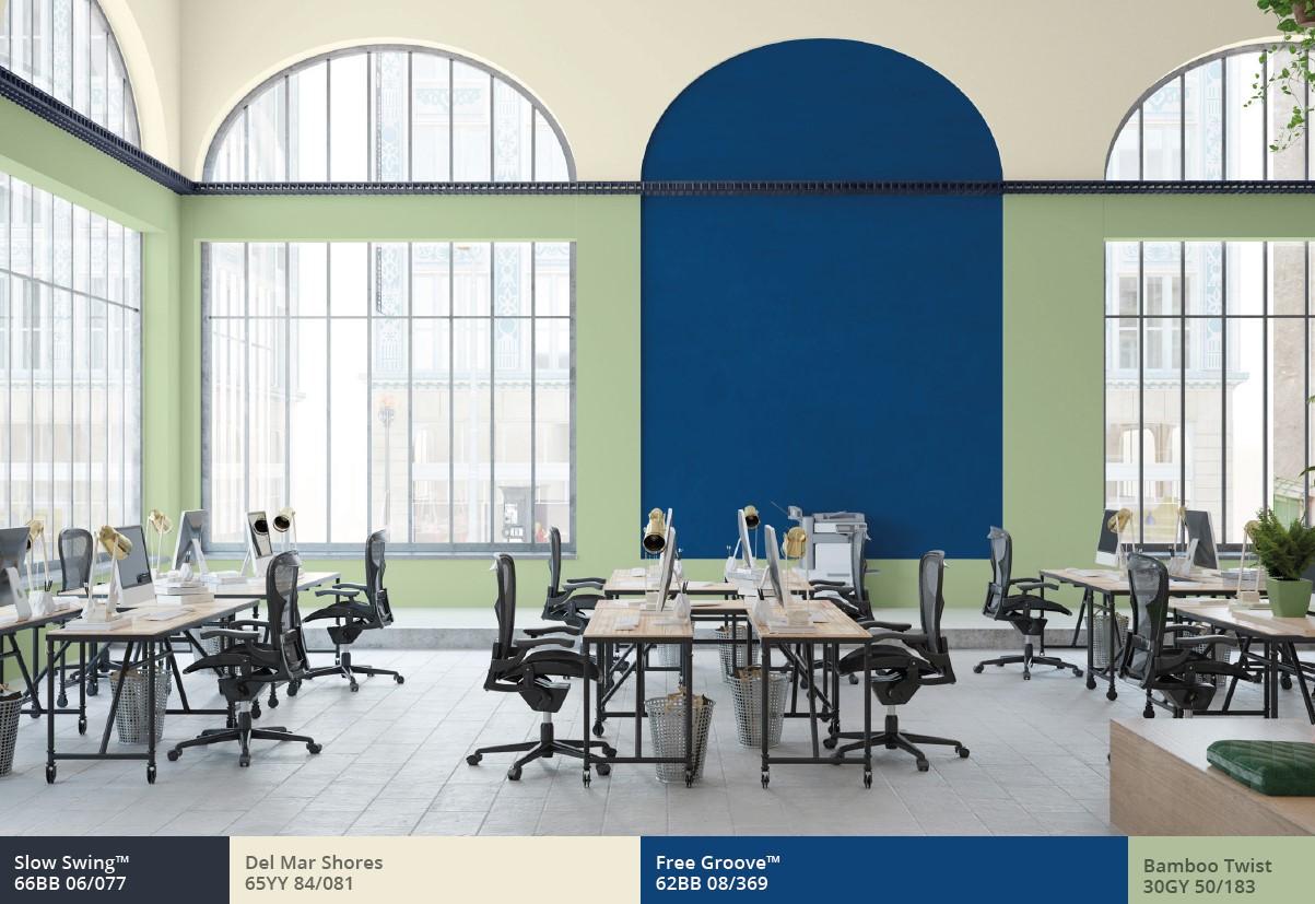 Open-plan office with arched windows, blue arch and green walls