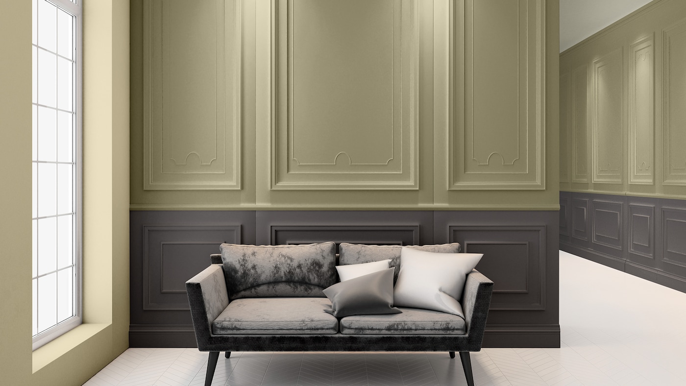 Een muur met kleurvlakken in een wachtruimte van een ziekenhuis met lambrisering en een sofa