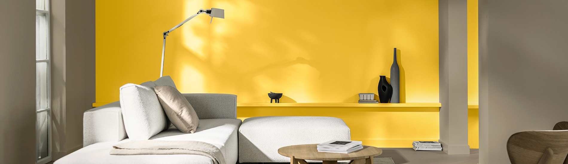 Living room with yellow wall and white sofa