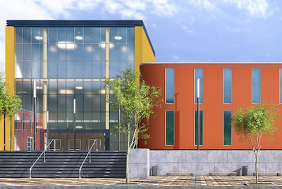 The exterior of a school brightly painted in yellow and orange