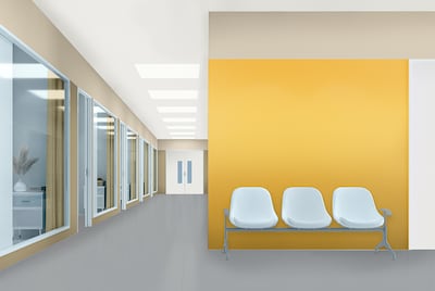 Waitingroom with white seats and yellow painted wall