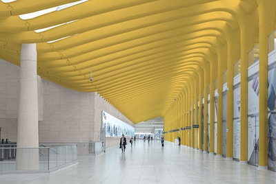 Grand entrance to an office with yellow wall and ceiling. 
