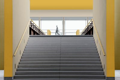 A stairwell with a wall painted using a split wall effect. 