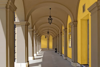 Long archway corridor with wide vaults with yellow accents
