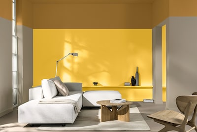 Living room with yellow feature wall and white sofa