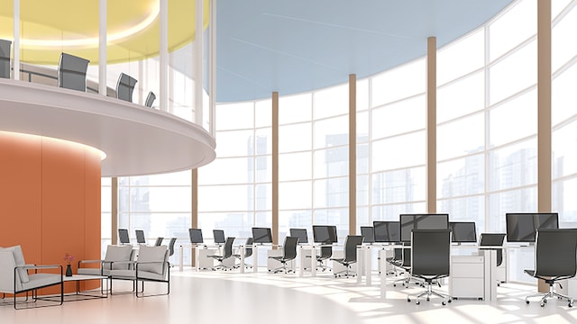 Rundt kontorlokale med gul og orange midtersektion 