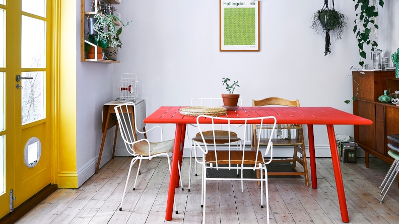 Dining room with red table and yellow doo