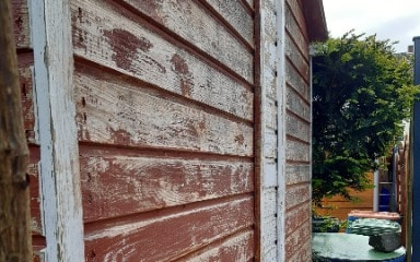 Ein altes Gartenhaus aus Holz, das für die Verwendung mit Consolan abgeschliffen wurde. Seitenansicht